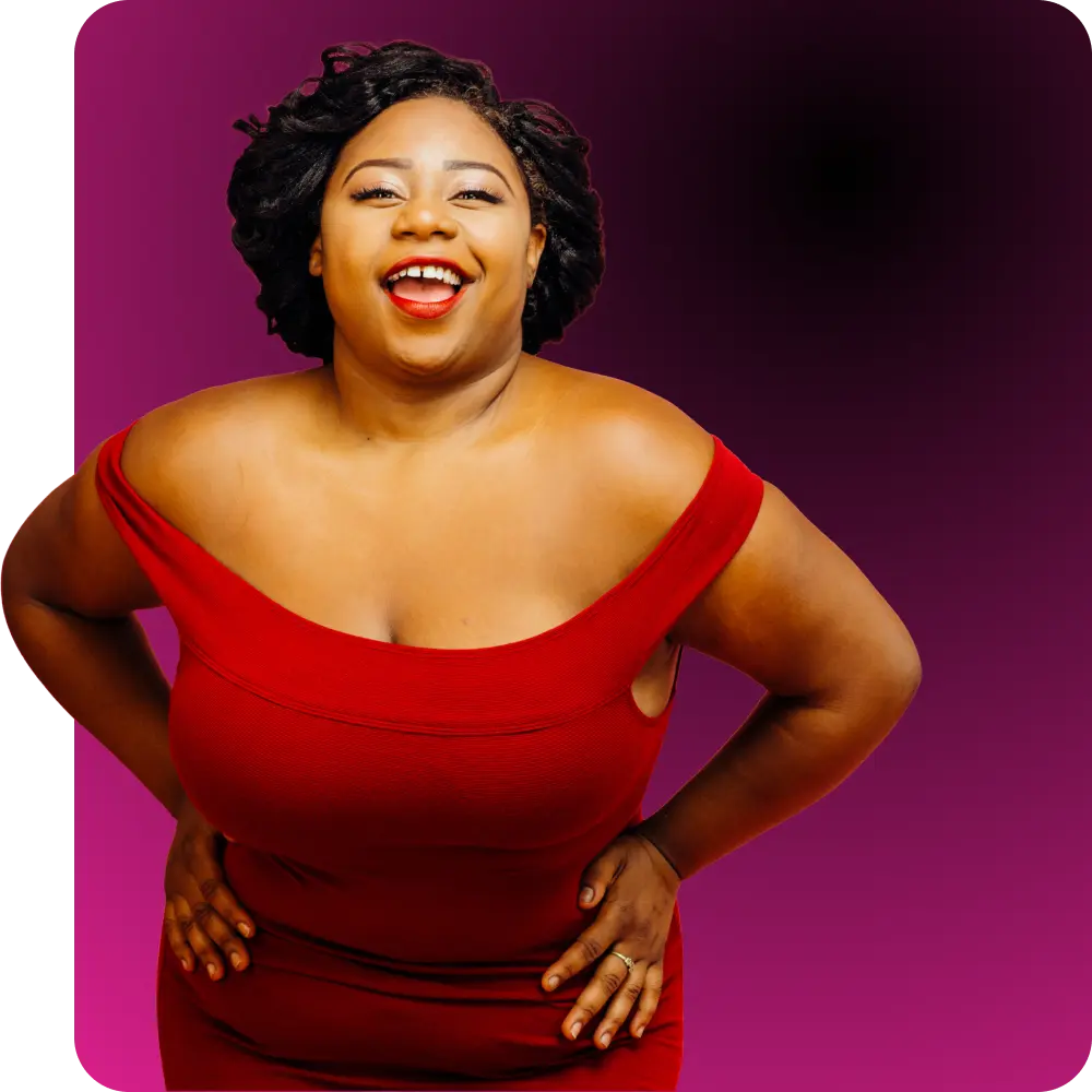 A confident, smiling woman in a red dress